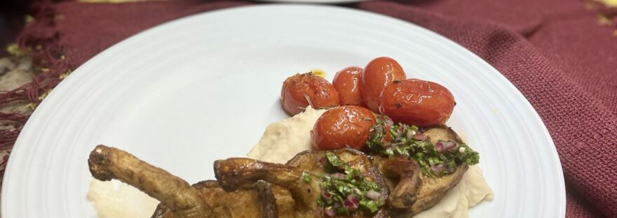 Prato com purê de feijão branco, cogumelos portobello assados e tomates confitados